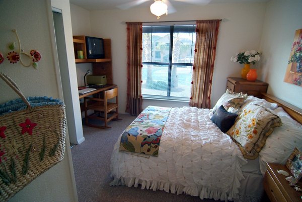 Modern bedroom with stylish decor in Reveille Ranch Apartments