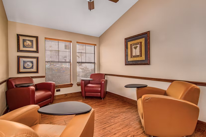 Modern clubhouse featuring cozy seating areas and a pool table at Reveille Ranch Apartments