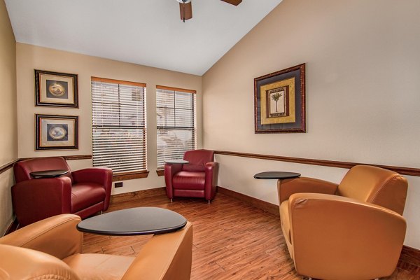 Modern clubhouse featuring cozy seating areas and a pool table at Reveille Ranch Apartments
