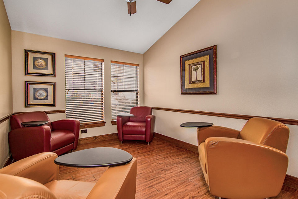 Modern clubhouse featuring cozy seating areas and a pool table at Reveille Ranch Apartments