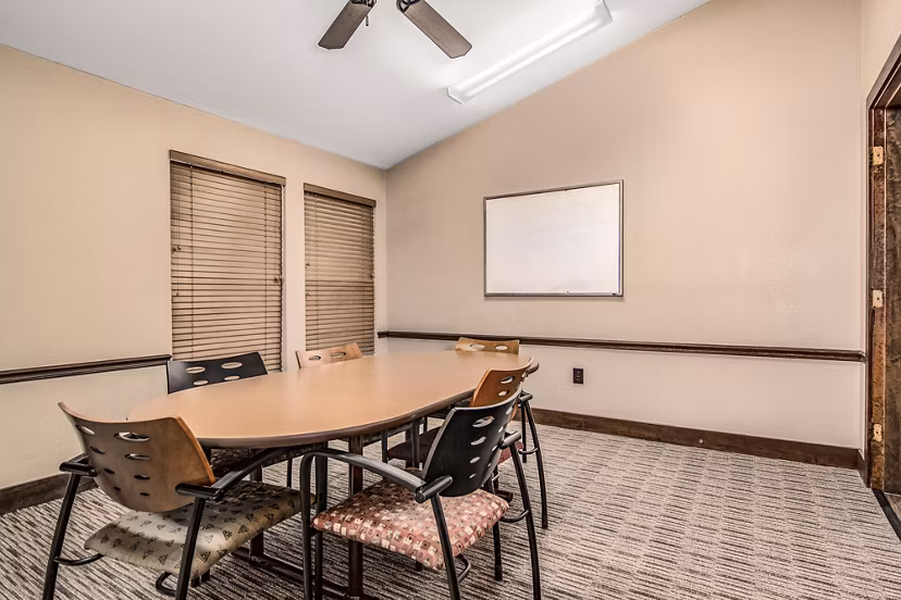 Modern meeting facility with spacious seating at Reveille Ranch Apartments, ideal for community gatherings and business events