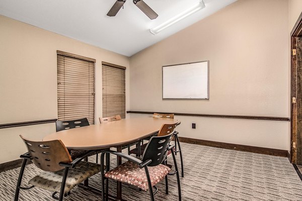 Modern meeting facility with spacious seating at Reveille Ranch Apartments, ideal for community gatherings and business events