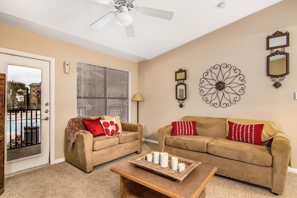 Spacious living room with modern decor and natural light in Reveille Ranch Apartments