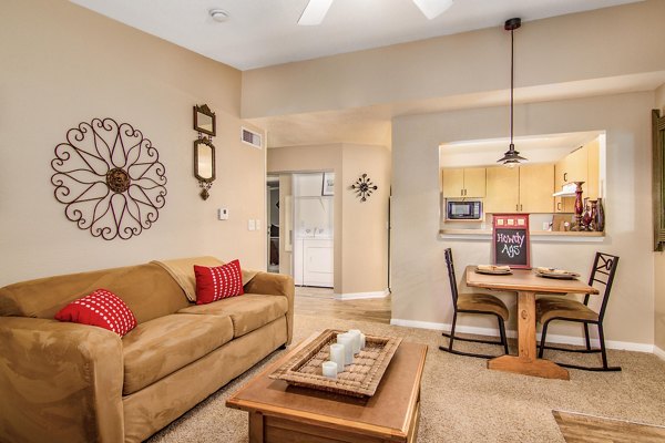 Spacious living room with modern decor at Reveille Ranch Apartments, offering comfort and style in luxury Greystar apartments