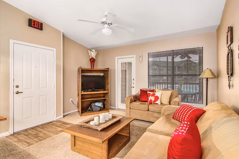 Spacious living room with modern furnishings in Reveille Ranch Apartments, perfect for relaxing and entertaining guests