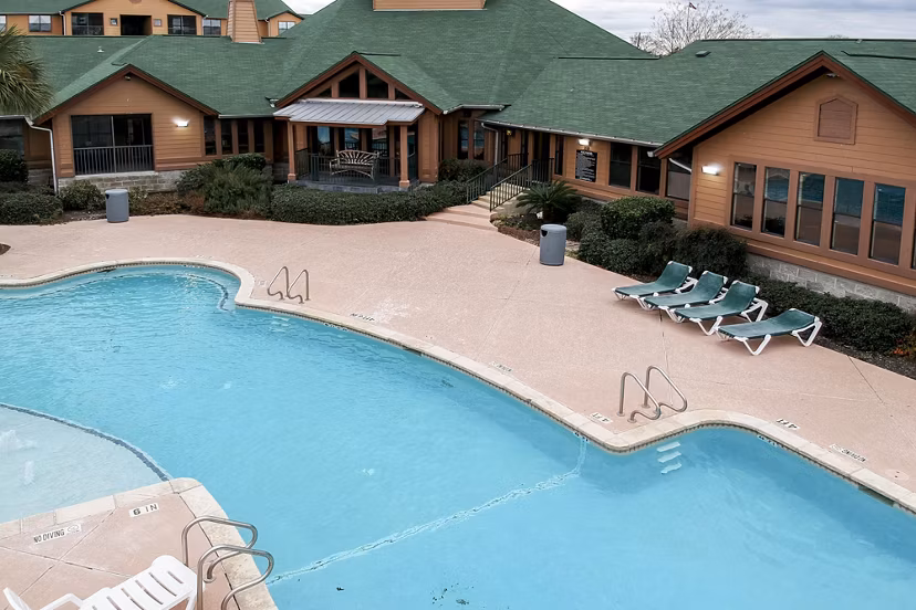 Sparkling pool at Reveille Ranch Apartments offering luxury outdoor relaxation in a serene setting