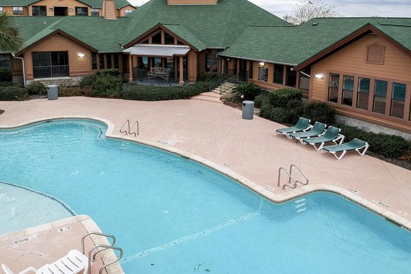 Sparkling pool at Reveille Ranch Apartments offering luxury outdoor relaxation in a serene setting