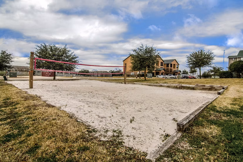 Sport court at Reveille Ranch Apartments: Modern outdoor facility offering basketball and tennis in a vibrant community setting