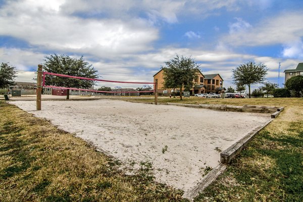 Sport court at Reveille Ranch Apartments: Modern outdoor facility offering basketball and tennis in a vibrant community setting