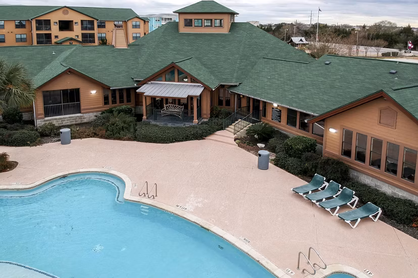 Reveille Ranch: Scenic view of luxury apartments surrounded by lush landscaping