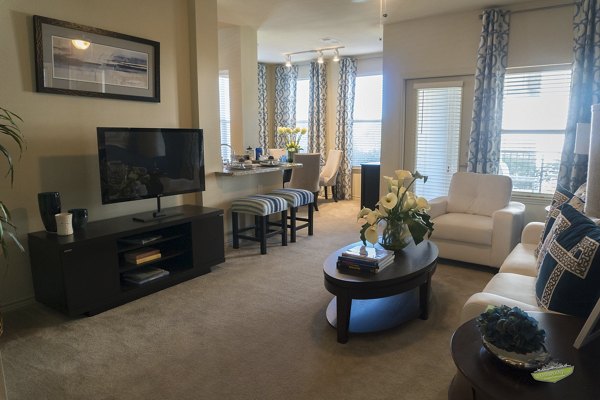 Modern living room with sleek furnishings and large windows at 21 Gramercy Park Apartments