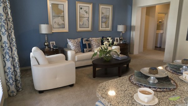 Living room with modern furnishings and natural light at 21 Gramercy Park Apartments, a Greystar luxury community