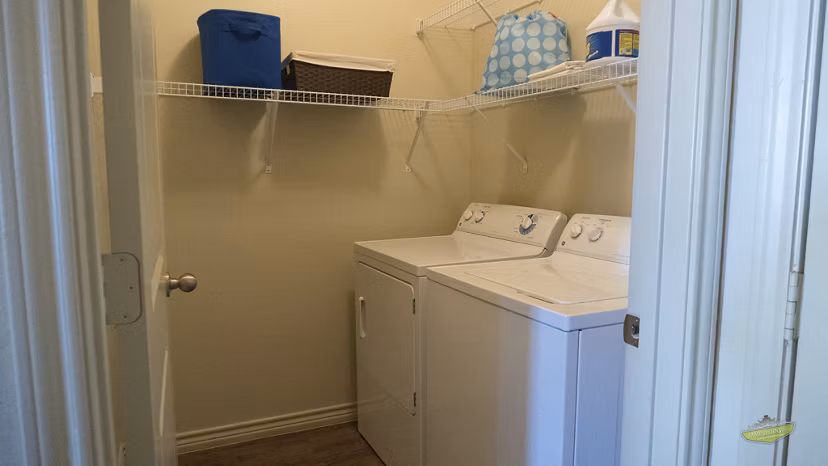 Laundry room with modern washer and dryer at 21 Gramercy Park Apartments