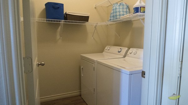 Laundry room with modern washer and dryer at 21 Gramercy Park Apartments
