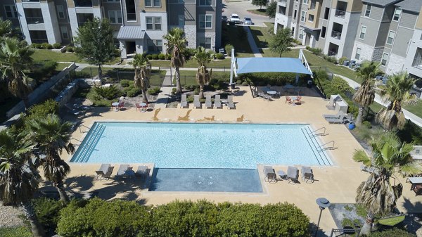 Luxurious pool with lounge chairs at 21 Gramercy Park Apartments, a Greystar luxury community