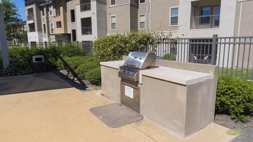 Outdoor BBQ area with modern grills at 21 Gramercy Park Apartments, perfect for gathering and entertaining residents in a luxurious setting
