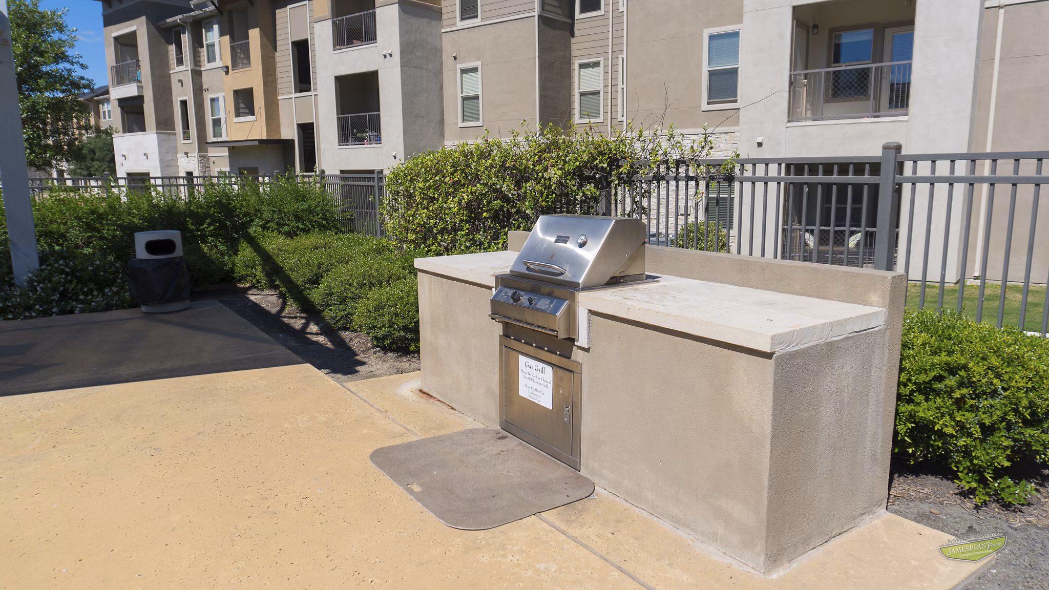 Outdoor BBQ area with modern grills at 21 Gramercy Park Apartments, perfect for gathering and entertaining residents in a luxurious setting