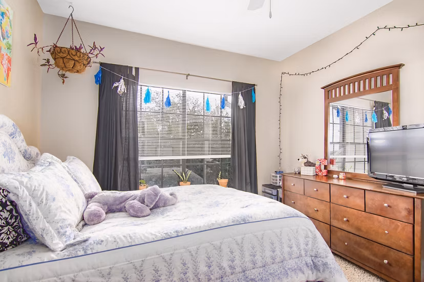 Cozy bedroom with modern furnishings at The Ridge Apartments