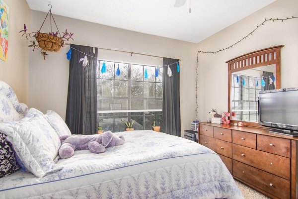 Cozy bedroom with modern furnishings at The Ridge Apartments