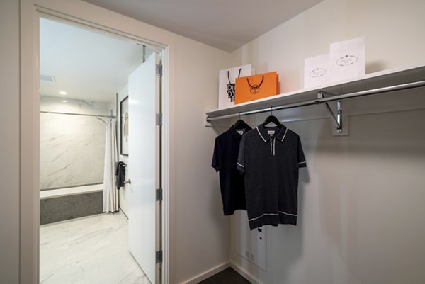 Spacious walk-in closet in a luxury apartment at THEA at Metropolis Apartments, featuring ample storage solutions