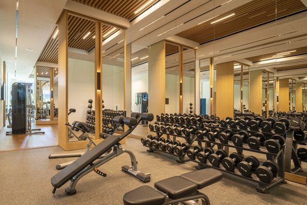 State-of-the-art fitness center at THEA at Metropolis Apartments, featuring modern equipment and spacious workout areas