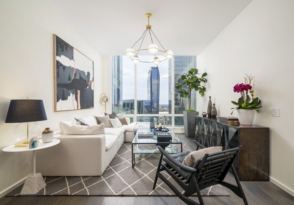 Spacious living room with modern furnishings in THEA at Metropolis Apartments