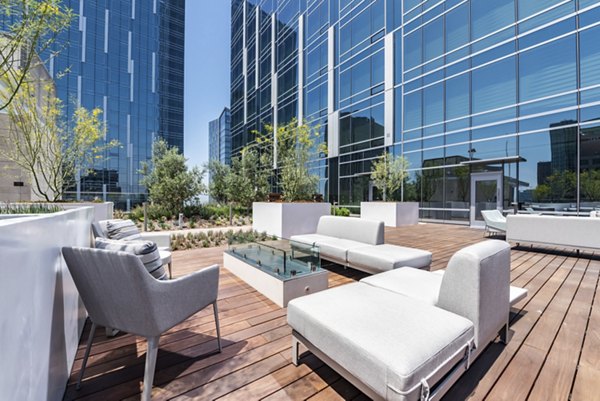 Cozy fire pit area at THEA at Metropolis Apartments, ideal for relaxation and socializing in a luxury urban setting