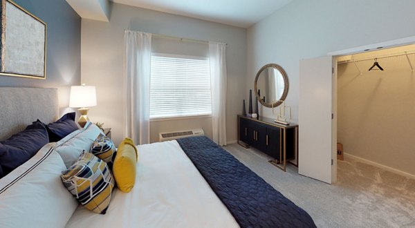 Bedroom featuring elegant modern furnishings at Nexus at Orenco Station Apartments
