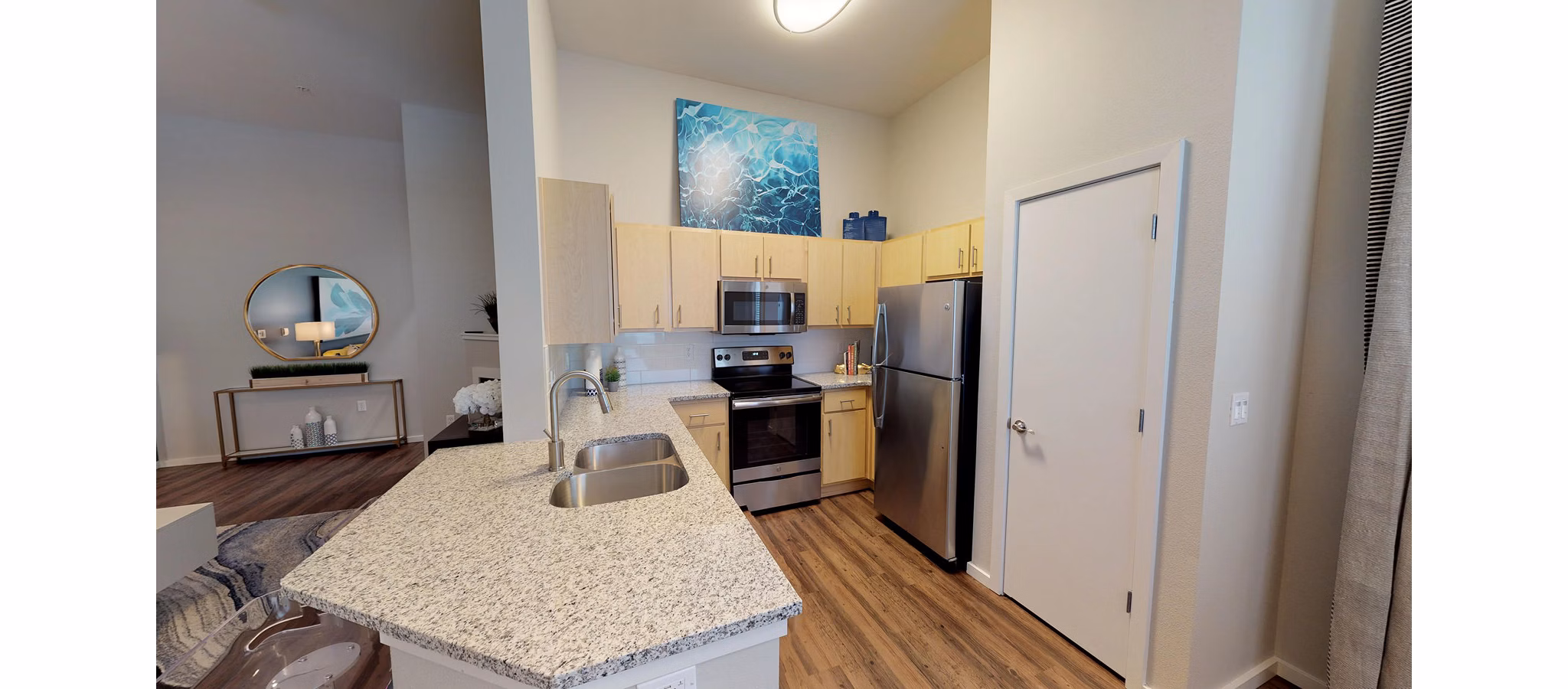 Modern kitchen with stainless steel appliances in Nexus at Orenco Station Apartments