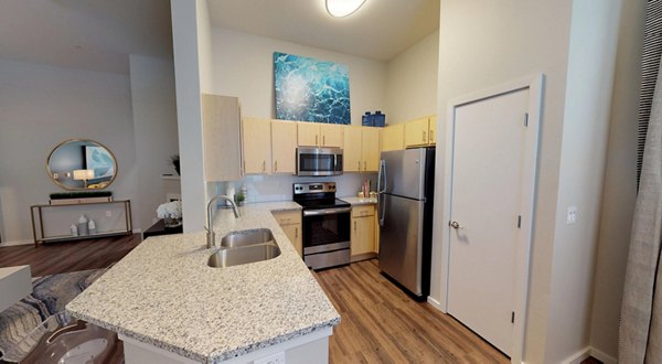 Modern kitchen with stainless steel appliances in Nexus at Orenco Station Apartments