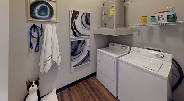 Laundry room with modern appliances at Nexus at Orenco Station Apartments