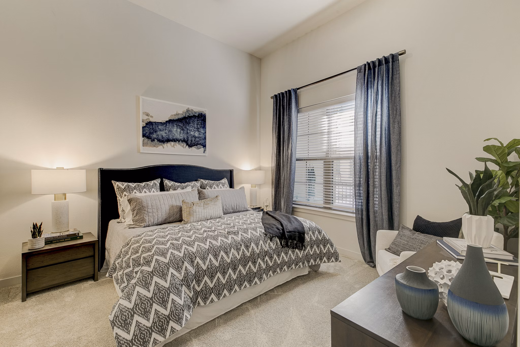 Cozy bedroom with modern decor at Addison Grove Apartments, featuring natural light and spacious layout