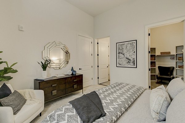 Cozy bedroom with modern decor at Addison Grove Apartments, perfect for luxury living