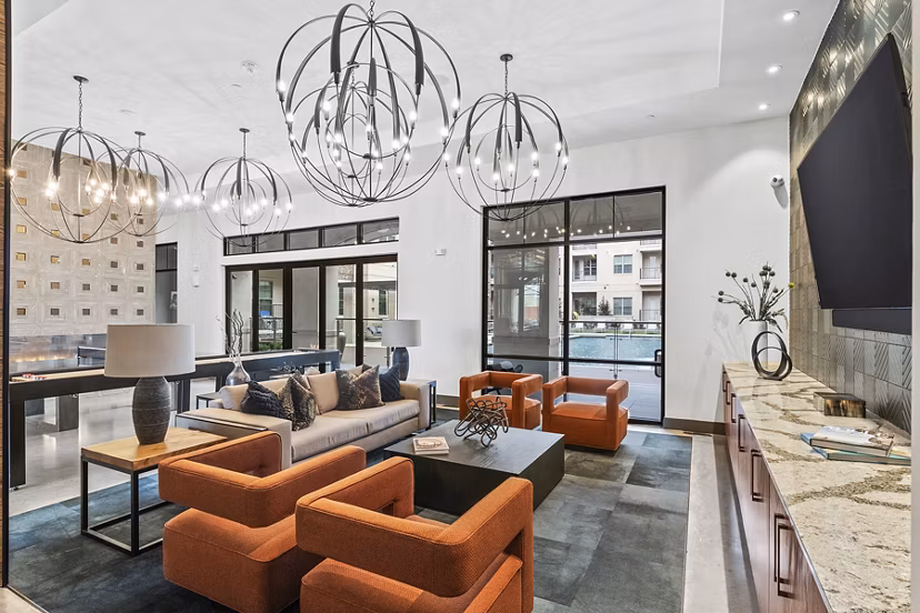 Clubhouse lobby with contemporary furnishings and elegant lighting at Elan Addison Grove Apartments