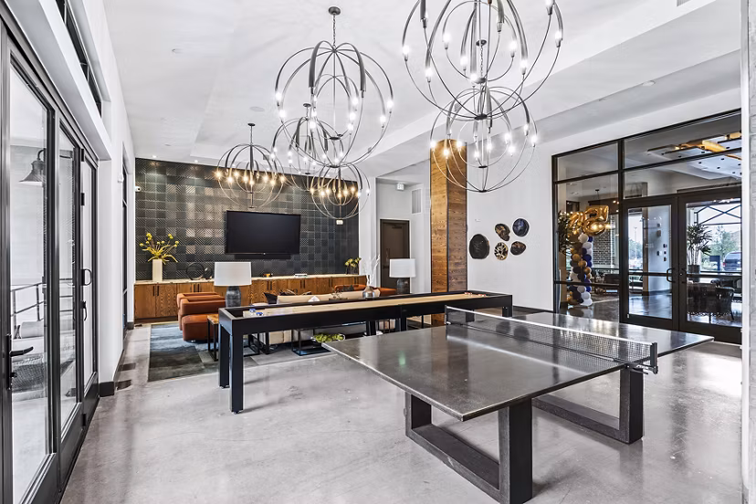 Elan Addison Grove Apartments: Modern clubhouse game room with pool table and lounge area
