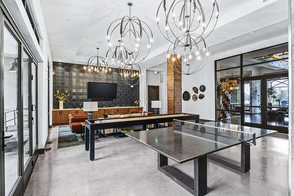 Elan Addison Grove Apartments: Modern clubhouse game room with pool table and lounge area