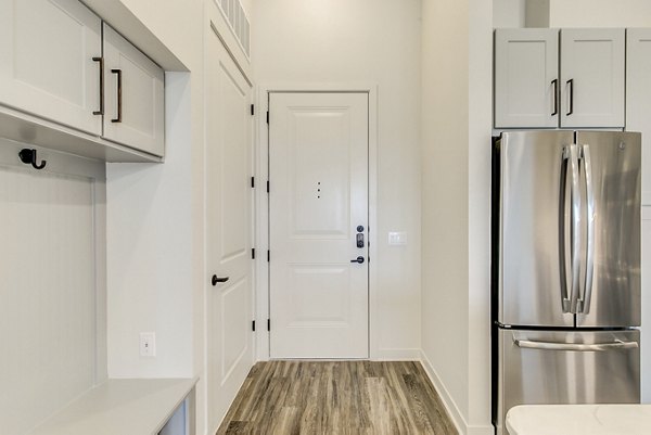 Modern kitchen with stainless steel appliances at Elan Addison Grove Apartments, ideal for luxury living