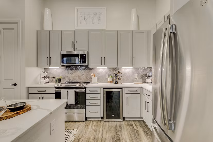 Modern kitchen with stainless steel appliances and sleek cabinetry in Addison Grove Apartments