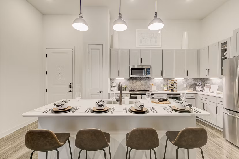 Addison Grove Apartments: Modern kitchen featuring stainless steel appliances and granite countertops