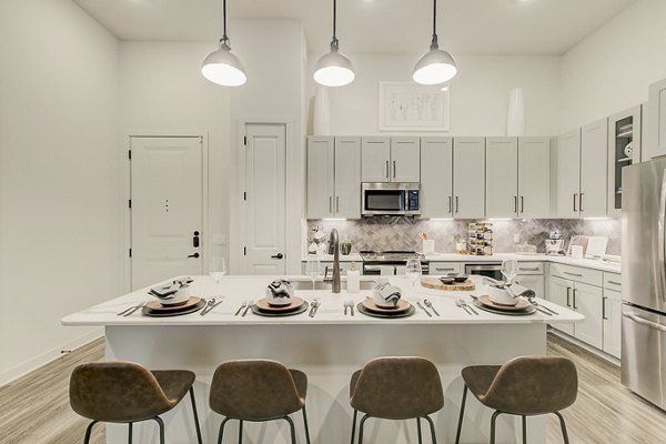 Addison Grove Apartments: Modern kitchen featuring stainless steel appliances and granite countertops