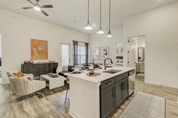 Modern kitchen with stainless steel appliances at Addison Grove Apartments