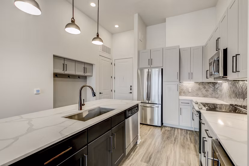 Modern kitchen with stainless steel appliances in Elan Addison Grove Apartments