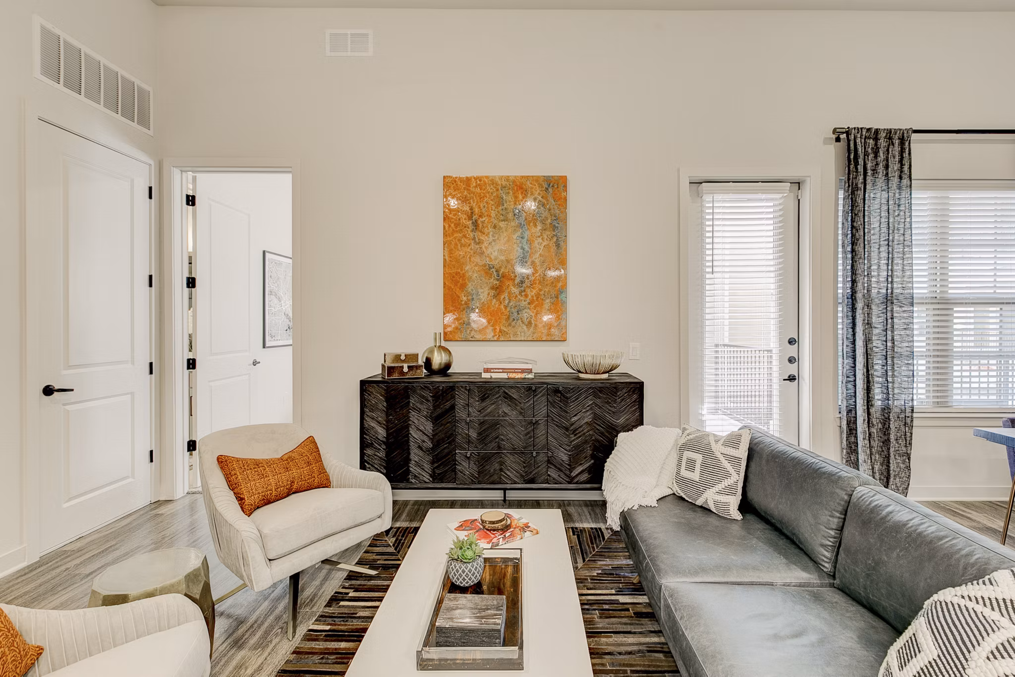Spacious living room with modern furnishings in Addison Grove Apartments