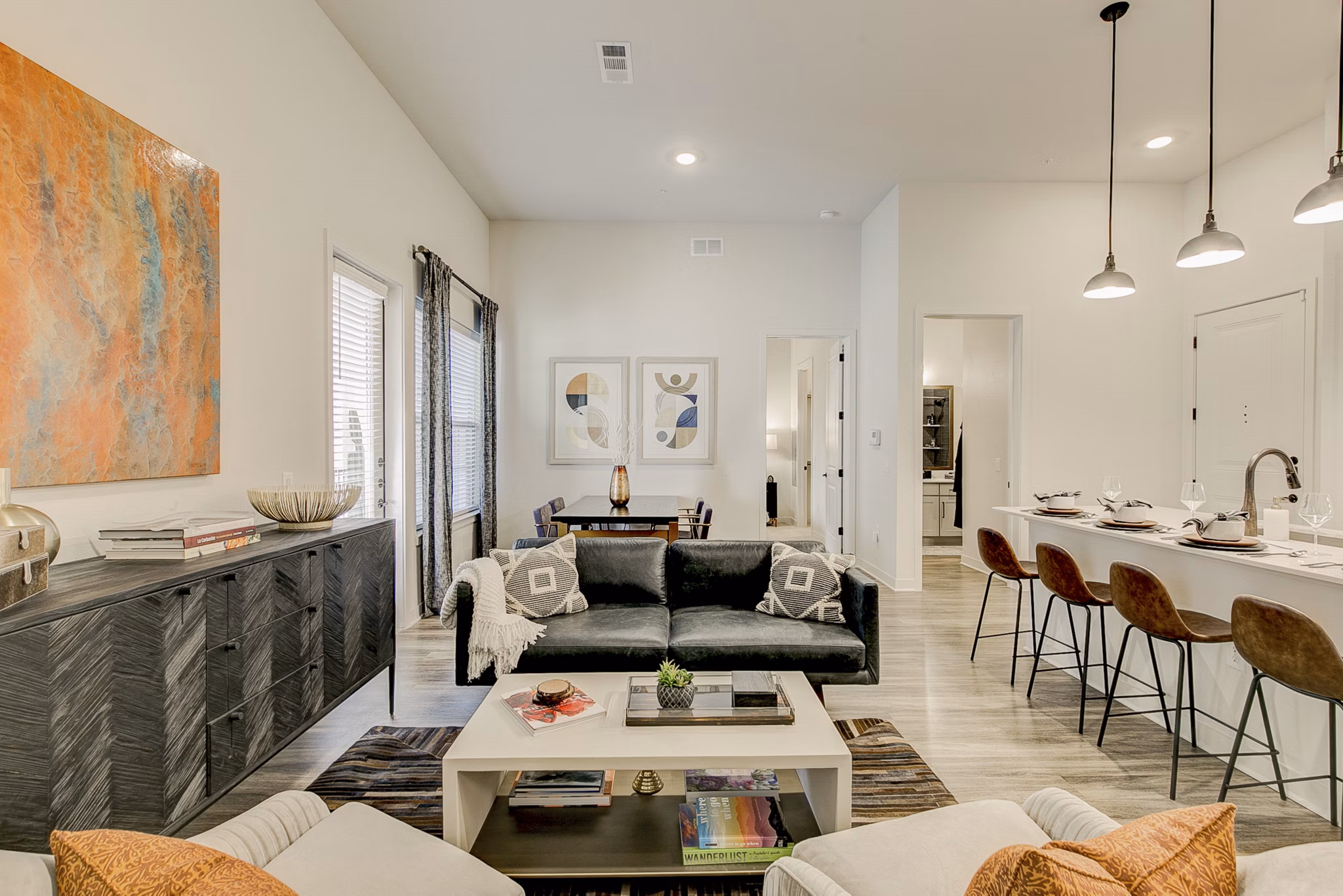 Spacious living room with modern decor and natural light in Addison Grove Apartments