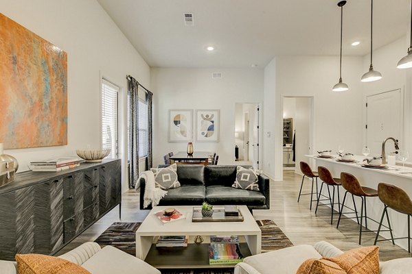Spacious living room with modern decor and natural light in Addison Grove Apartments