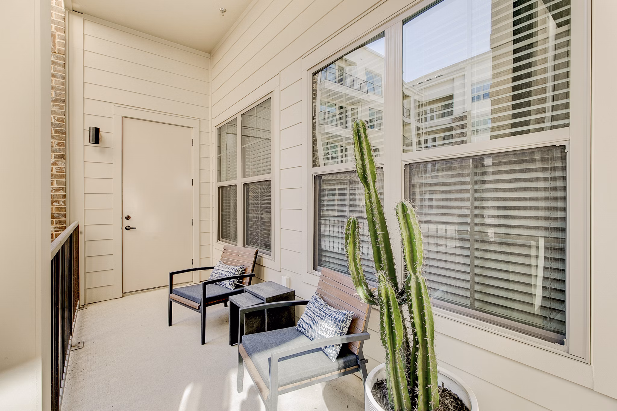 Outdoor patio area at Addison Grove Apartments featuring stylish seating under shaded pergola Ideal space for relaxation and socializing