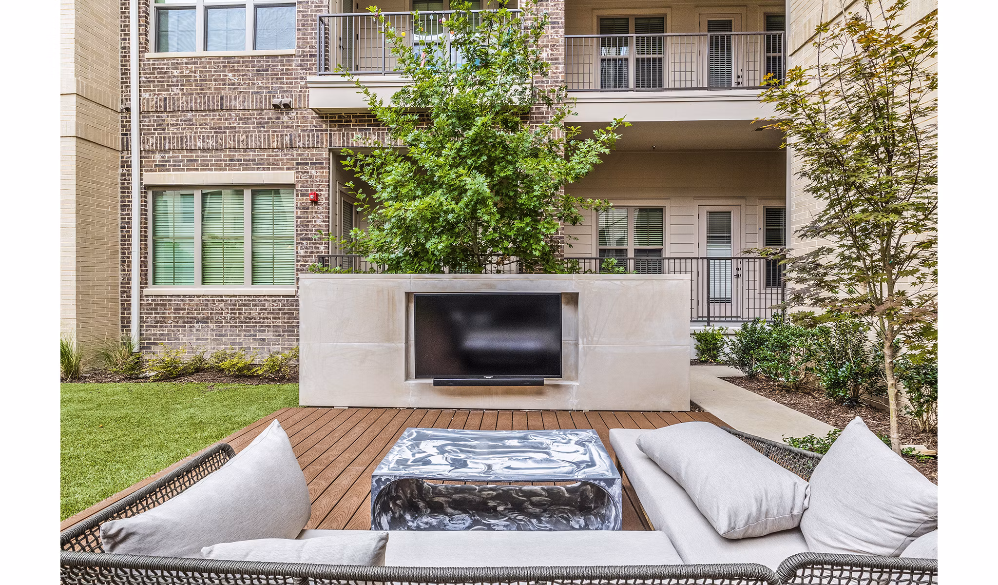 Outdoor patio with modern furniture at Elan Addison Grove Apartments, offering luxury living and relaxation spaces in a prime location