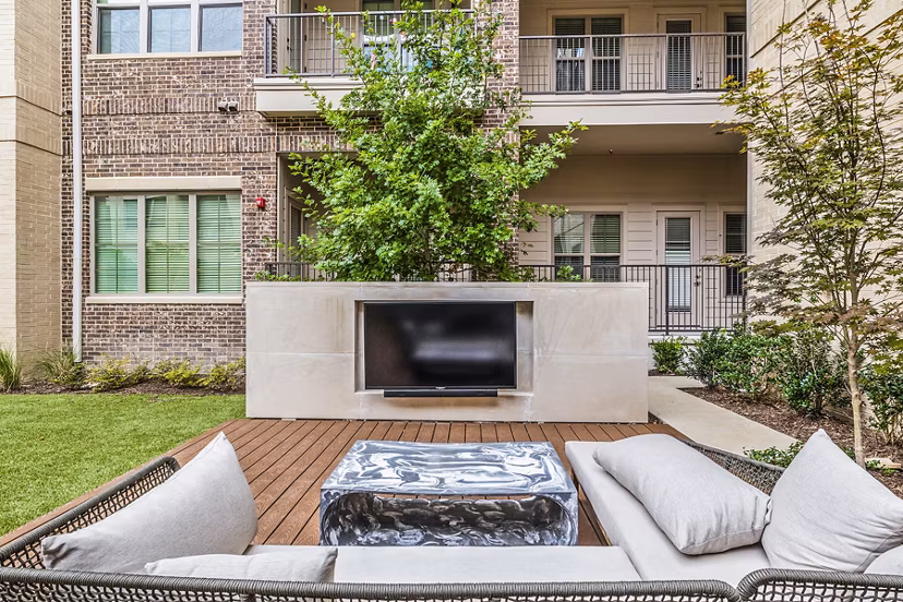 Outdoor patio with modern furniture at Elan Addison Grove Apartments, offering luxury living and relaxation spaces in a prime location