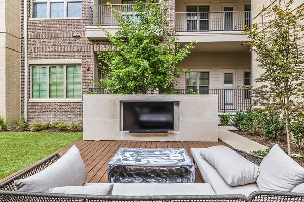 Outdoor patio with modern furniture at Elan Addison Grove Apartments, offering luxury living and relaxation spaces in a prime location