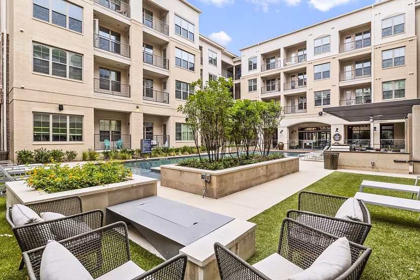 Pool with sun deck at Elan Addison Grove Apartments: Luxury space in prime location offering relaxation and comfort